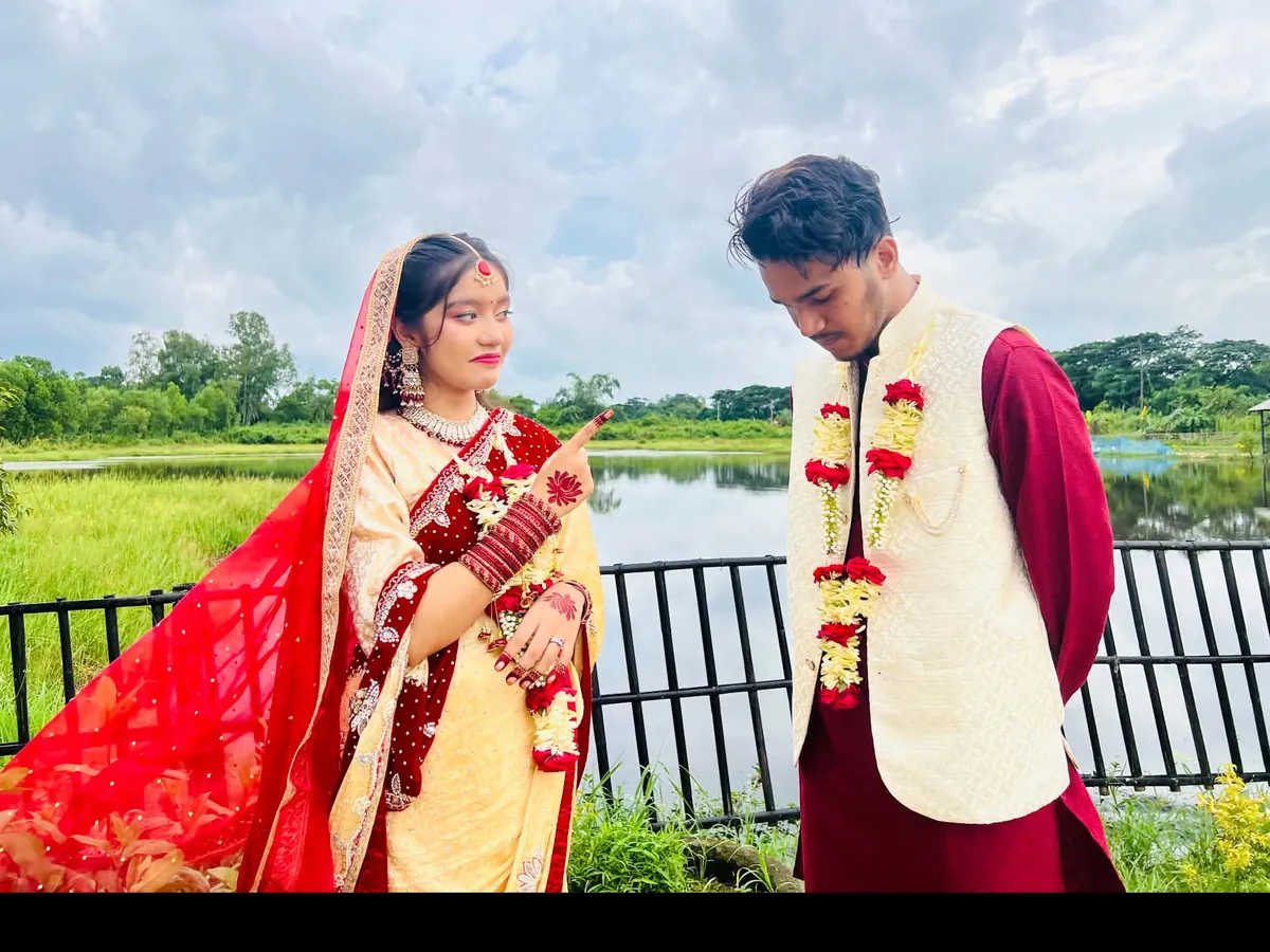 The bride playfully pointing a finger while the groom looks down